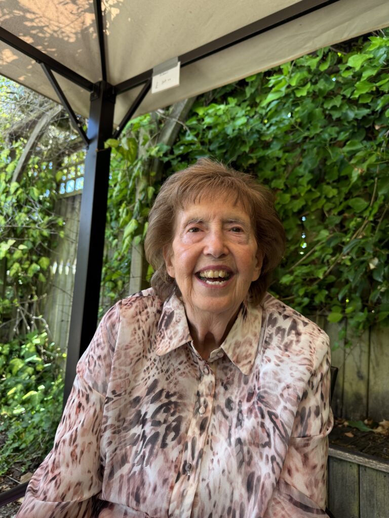 Lovely happy lady enjoying lunch in the sun with her carer at 1 Oak Colchester
