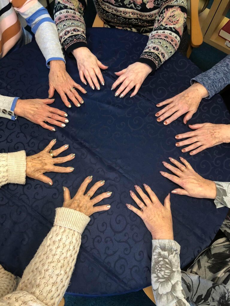 Lots of members hands in a circle showing off their freshly painted nails at the 1 Oak Chilton Club daycentre