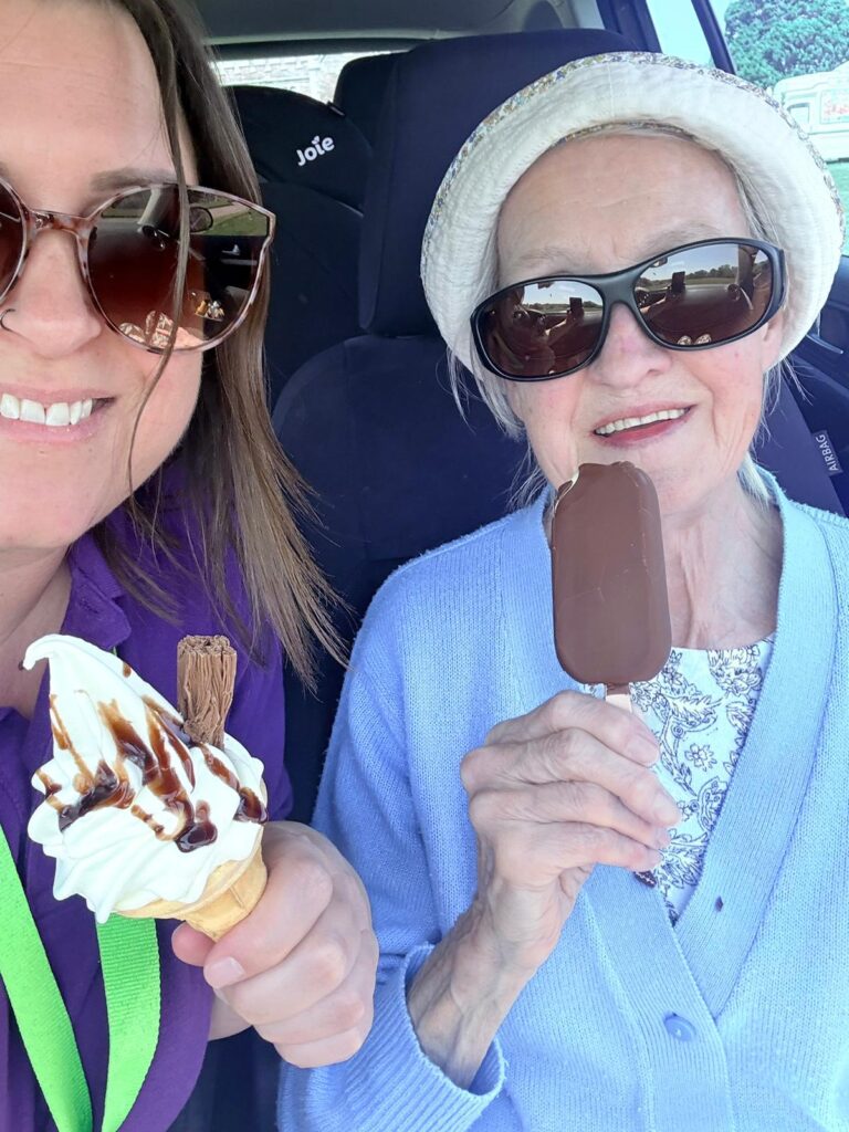 Sudbury Home Care Client enjoying some ice cream in the sun and happy, smiling and enjoying companionship with her carer.